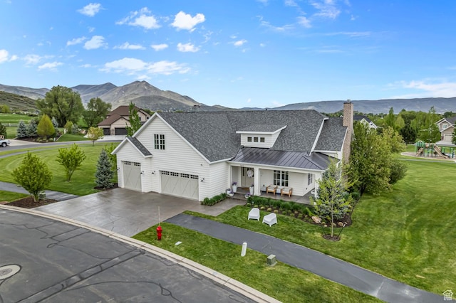 567 W Cascade Meadows Loop S, Midway, UT 84049 - view of front facade featuring a porch, a standing seam roof, a mountain view, concrete driveway, and a shingled roof