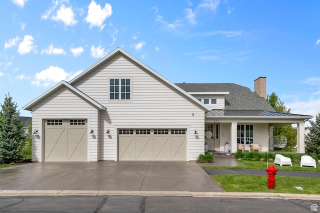 567 W Cascade Meadows Loop S, Midway, UT 84049 - view of front of home featuring a standing seam roof, a porch, concrete driveway, metal roof, and an attached garage