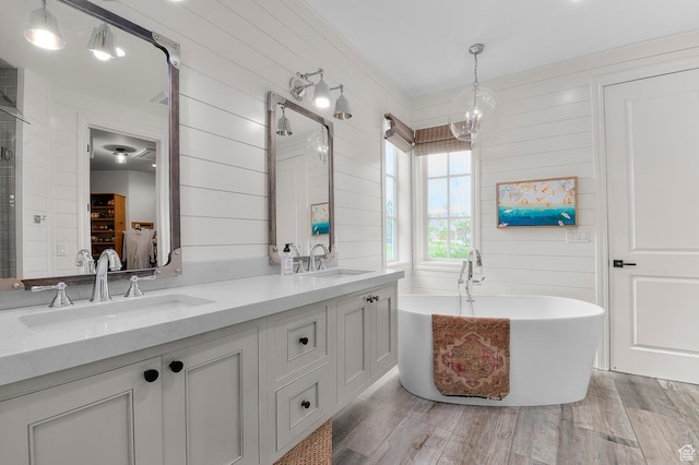 567 W Cascade Meadows Loop S, Midway, UT 84049 - full bathroom with wood finished floors, a soaking tub, double vanity, a chandelier, and wooden walls