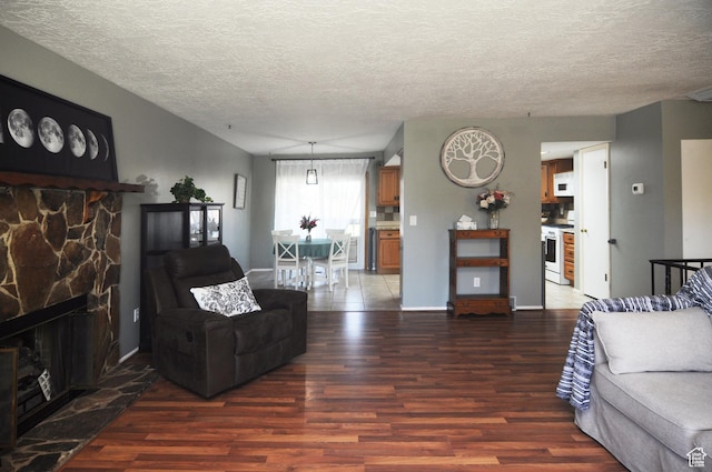 1185 W 725 N, Clearfield, UT 84015 - living area featuring wood finished floors, a textured ceiling, a fireplace, and baseboards