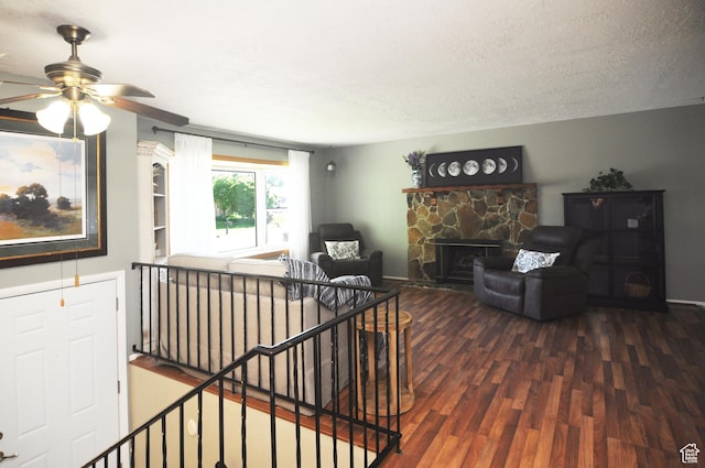 1185 W 725 N, Clearfield, UT 84015 - living area with wood finished floors, a ceiling fan, a fireplace, and a textured ceiling