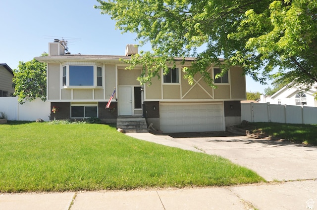 1185 W 725 N, Clearfield, UT 84015 - bi-level home featuring a garage, a chimney, driveway, brick siding, and stucco siding