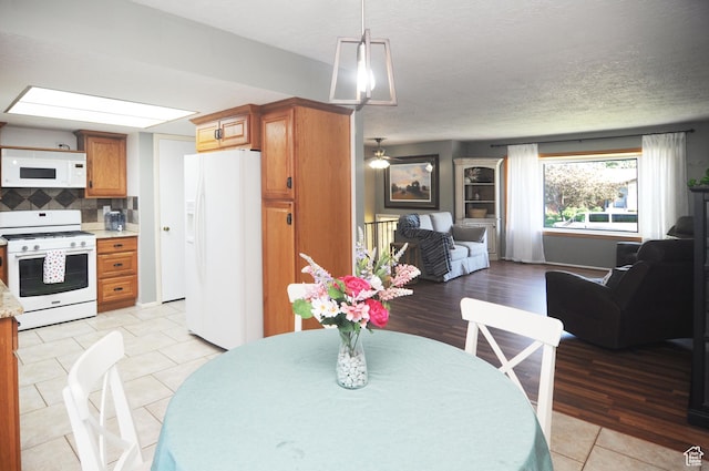 1185 W 725 N, Clearfield, UT 84015 - dining room with a textured ceiling and light tile patterned floors