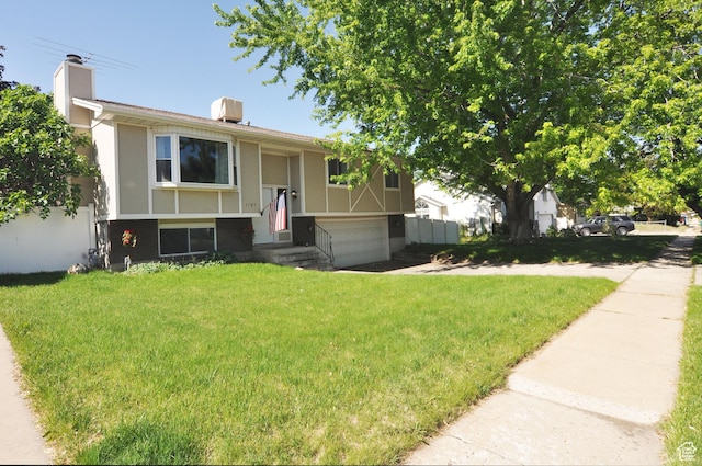 1185 W 725 N, Clearfield, UT 84015 - split foyer home featuring an attached garage, a chimney, and stucco siding