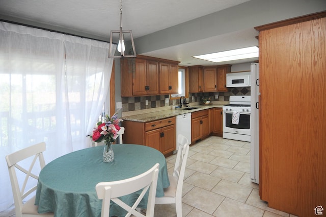1185 W 725 N, Clearfield, UT 84015 - kitchen with white appliances, brown cabinets, backsplash, light tile patterned floors, and a sink
