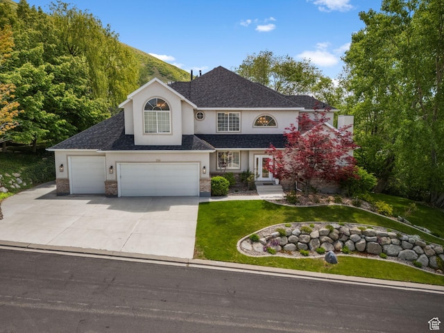 2016 E Graystone Ln S, Draper, UT 84020 - traditional home featuring stucco siding, a front lawn, driveway, a garage, and roof with shingles
