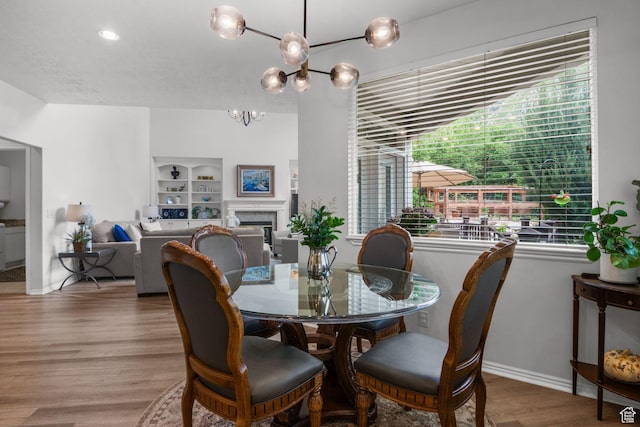2016 E Graystone Ln S, Draper, UT 84020 - dining room featuring a chandelier, wood finished floors, baseboards, and a fireplace