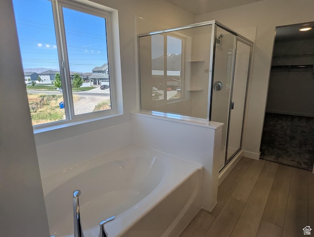 737 N Plainsman Dr Unit 108, Spanish Fork, UT 84660 - full bathroom with a garden tub, a stall shower, a spacious closet, and hardwood / wood-style flooring