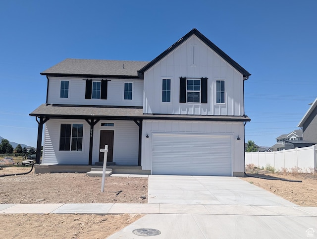 737 N Plainsman Dr Unit 108, Spanish Fork, UT 84660 - view of front of house with covered porch, an attached garage, driveway, a shingled roof, and board and batten siding