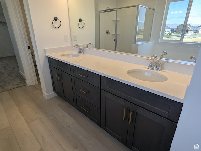 737 N Plainsman Dr Unit 108, Spanish Fork, UT 84660 - full bathroom with a stall shower, double vanity, and wood finished floors