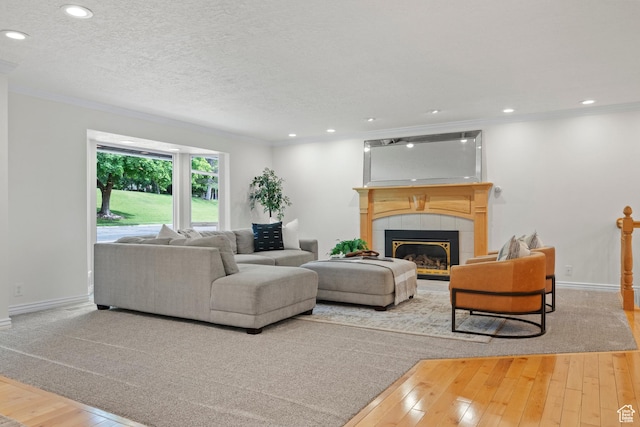 2592 S 50 W, Bountiful, UT 84010 - living area with hardwood / wood-style flooring, ornamental molding, a tile fireplace, baseboards, and recessed lighting