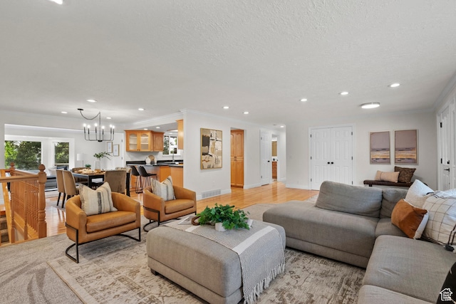 2592 S 50 W, Bountiful, UT 84010 - living area featuring a chandelier, recessed lighting, ornamental molding, a textured ceiling, and light wood-style floors