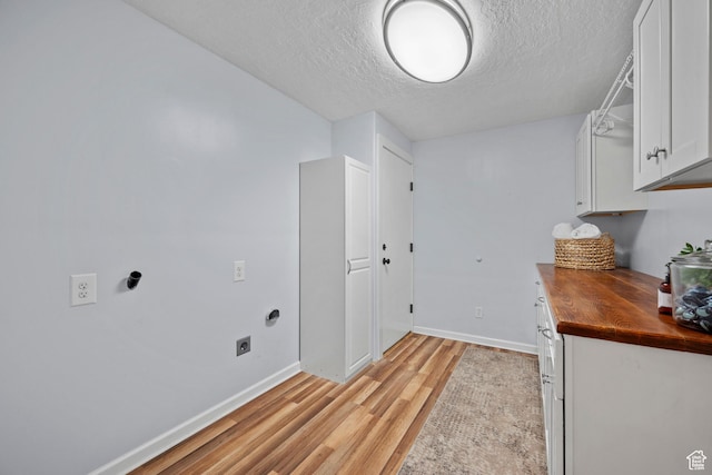 2592 S 50 W, Bountiful, UT 84010 - washroom featuring hookup for an electric dryer, light wood finished floors, a textured ceiling, cabinet space, and baseboards
