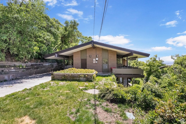 1900 N 1400 E, Provo, UT 84604 - view of property exterior with brick siding and a balcony