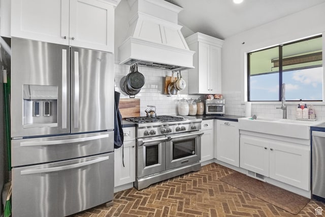 1900 N 1400 E, Provo, UT 84604 - kitchen with stainless steel appliances, premium range hood, a sink, white cabinetry, and backsplash