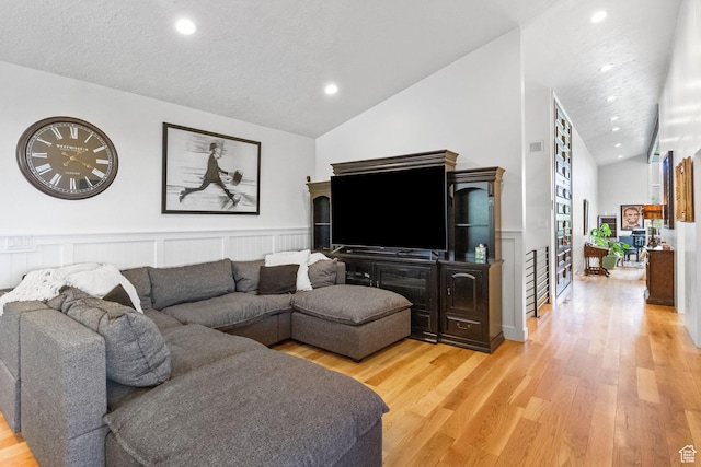 1900 N 1400 E, Provo, UT 84604 - living area featuring vaulted ceiling, light wood finished floors, wainscoting, recessed lighting, and a decorative wall