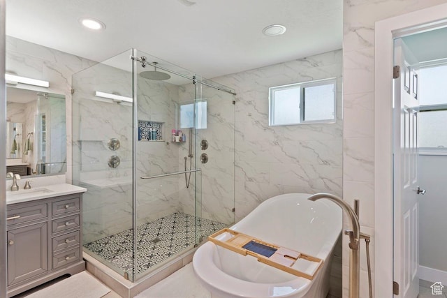 2149 E 3325 N, Layton, UT 84040 - bathroom with a freestanding bath, a marble finish shower, vanity, recessed lighting, and tile walls