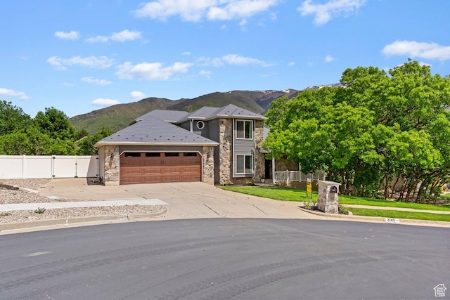 2149 E 3325 N, Layton, UT 84040 - traditional home featuring stone siding, a mountain view, a garage, a gate, and driveway