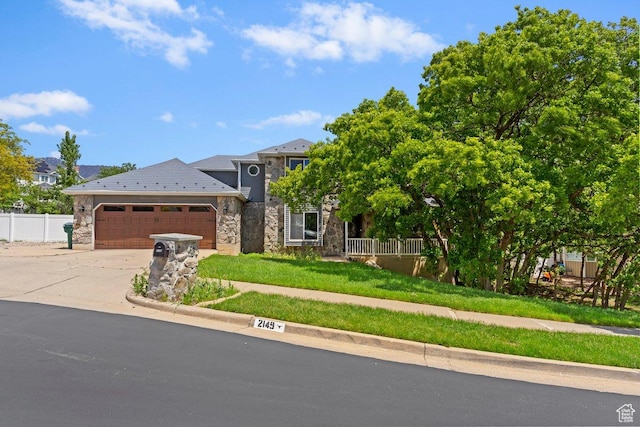 2149 E 3325 N, Layton, UT 84040 - view of front of property with stone siding, a garage, and concrete driveway