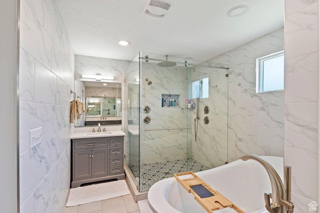 2149 E 3325 N, Layton, UT 84040 - bathroom featuring a marble finish shower, vanity, a bathtub, tile walls, and recessed lighting