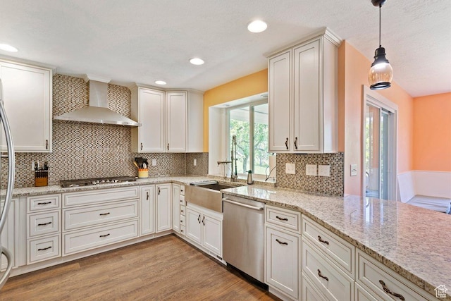 2149 E 3325 N, Layton, UT 84040 - kitchen with wall chimney range hood, stainless steel appliances, light wood-type flooring, a sink, and decorative light fixtures