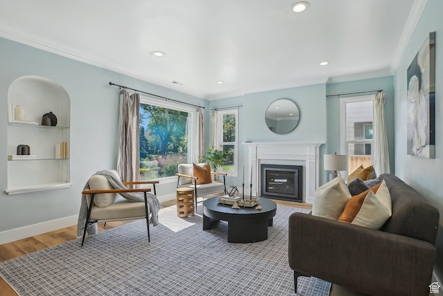 2672 S Filmore St, Salt Lake City, UT 84106 - living room featuring crown molding, a glass covered fireplace, wood finished floors, recessed lighting, and baseboards