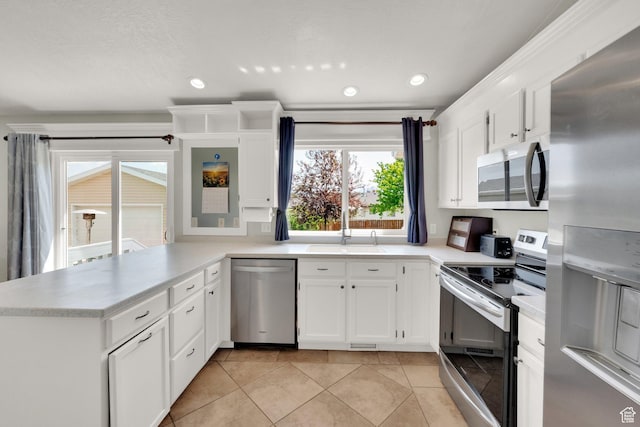 7215 S Aerie Hill Dr W, West Jordan, UT 84081 - kitchen with appliances with stainless steel finishes, a sink, a peninsula, light countertops, and recessed lighting