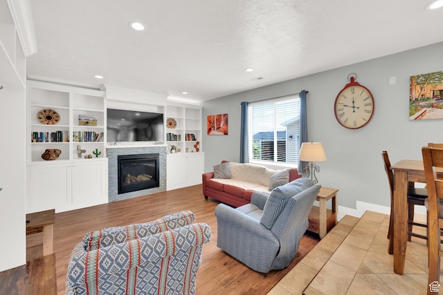7215 S Aerie Hill Dr W, West Jordan, UT 84081 - living room with a glass covered fireplace, wood finished floors, recessed lighting, and baseboards