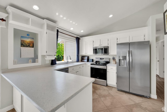 7215 S Aerie Hill Dr W, West Jordan, UT 84081 - kitchen with stainless steel appliances, a peninsula, a sink, white cabinetry, and vaulted ceiling