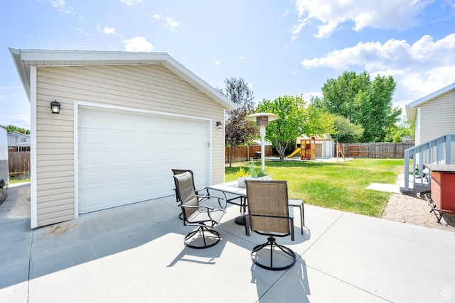 7215 S Aerie Hill Dr W, West Jordan, UT 84081 - view of patio featuring an outbuilding, a playground, outdoor dining area, and a garage
