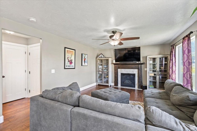 2007 N 850 E, North Ogden, UT 84414 - living room with ceiling fan, wood finished floors, a textured ceiling, a high end fireplace, and baseboards