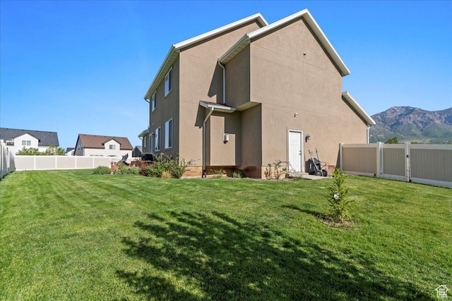 2007 N 850 E, North Ogden, UT 84414 - rear view of house featuring a mountain view, stucco siding, and a gate