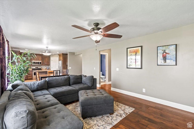 2007 N 850 E, North Ogden, UT 84414 - living room with baseboards, dark wood finished floors, ceiling fan, and a textured ceiling