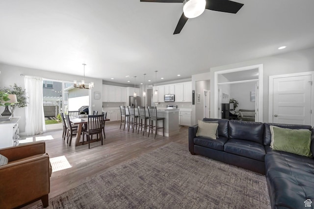 6178 W Sugarcane Dr, South Jordan, UT 84009 - living room featuring a chandelier, ceiling fan, light wood-style floors, a desk, and recessed lighting