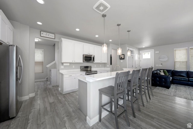 6178 W Sugarcane Dr, South Jordan, UT 84009 - kitchen featuring stainless steel appliances, baseboards, light wood-style floors, white cabinetry, and recessed lighting