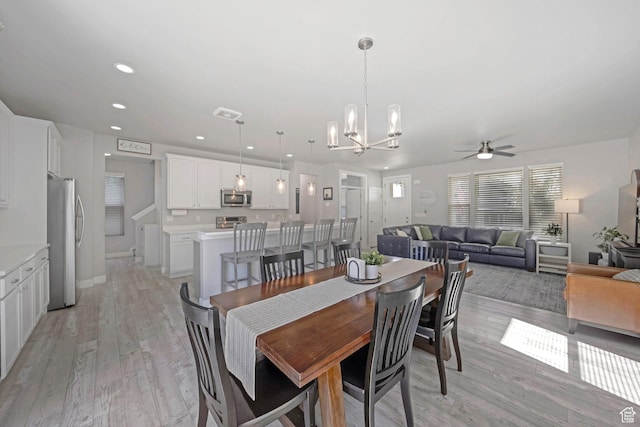 6178 W Sugarcane Dr, South Jordan, UT 84009 - dining area with a ceiling fan, a chandelier, light wood-style flooring, and recessed lighting