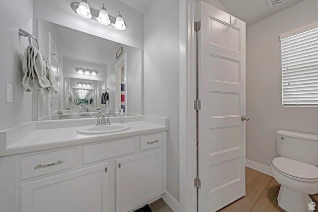 6178 W Sugarcane Dr, South Jordan, UT 84009 - bathroom with vanity, toilet, baseboards, and wood finished floors