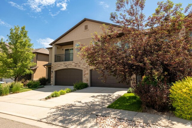 688 N 255 W, Centerville, UT 84014 - multi unit property featuring driveway, a garage, a balcony, stucco siding, and stone siding
