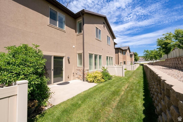 688 N 255 W, Centerville, UT 84014 - back of property with stucco siding, a patio, stone siding, and a residential view