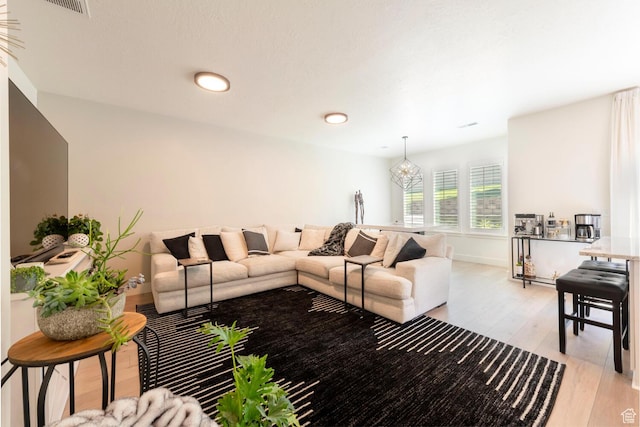 688 N 255 W, Centerville, UT 84014 - living area featuring light wood-style floors, a chandelier, and baseboards