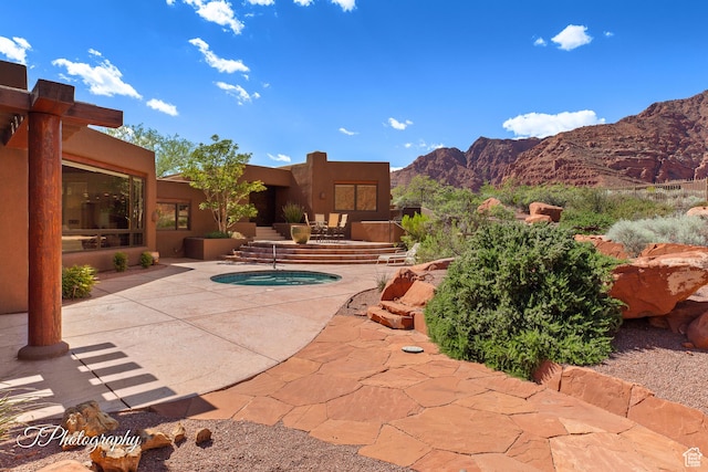 1936 N Uwan Dr, Ivins, UT 84738 - view of pool featuring a mountain view, a patio area, and an in-ground hot tub