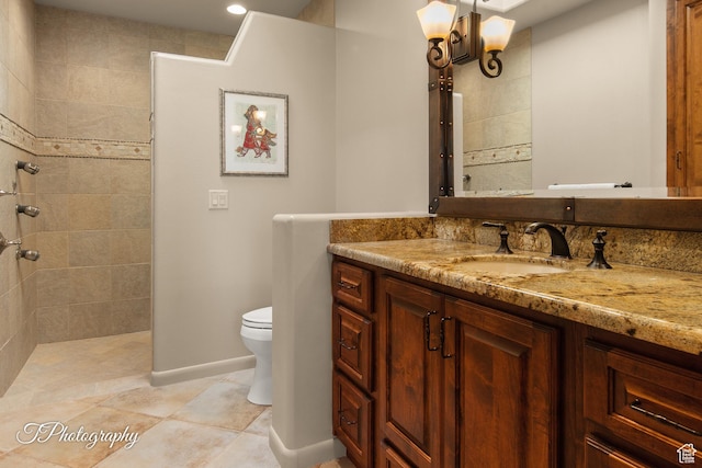 1936 N Uwan Dr, Ivins, UT 84738 - bathroom with vanity, toilet, tiled shower, tile patterned flooring, and baseboards