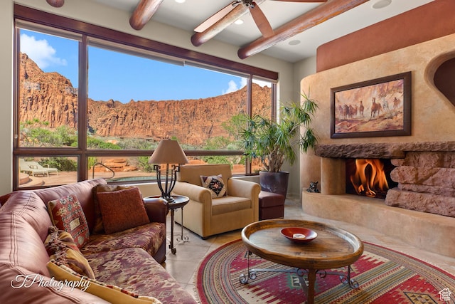 1936 N Uwan Dr, Ivins, UT 84738 - living room with a mountain view, beam ceiling, plenty of natural light, light tile patterned floors, and ceiling fan