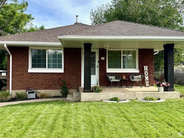 52 W 2000 N, Sunset, UT 84015 - view of front of home featuring a porch, roof with shingles, and brick siding