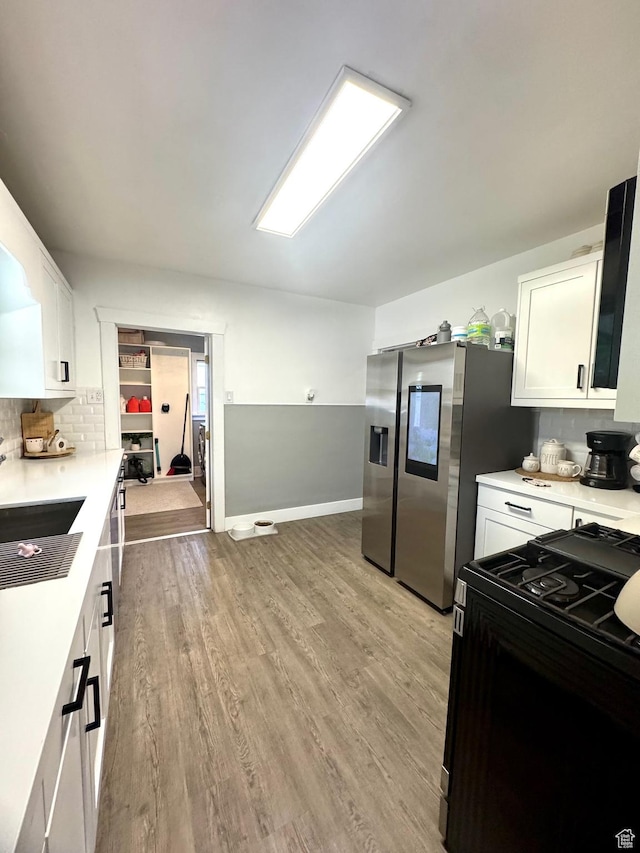 52 W 2000 N, Sunset, UT 84015 - kitchen with black range with gas cooktop, white cabinetry, light countertops, and light wood-style flooring