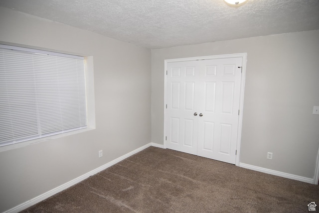 2236 E 1480 S, Spanish Fork, UT 84660 - unfurnished bedroom with carpet, a textured ceiling, a closet, and baseboards