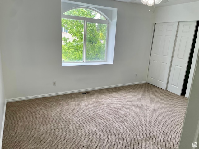6939 S Florentine Way, West Jordan, UT 84084 - unfurnished bedroom featuring light carpet, a closet, baseboards, and ceiling fan
