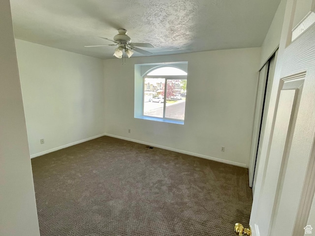 6939 S Florentine Way, West Jordan, UT 84084 - unfurnished bedroom with dark carpet, a closet, and a ceiling fan