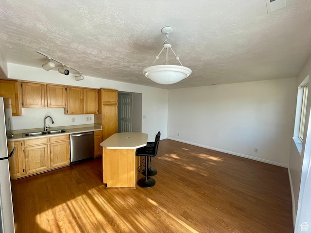 6939 S Florentine Way, West Jordan, UT 84084 - kitchen featuring stainless steel appliances, light countertops, dark wood finished floors, a center island, and a breakfast bar