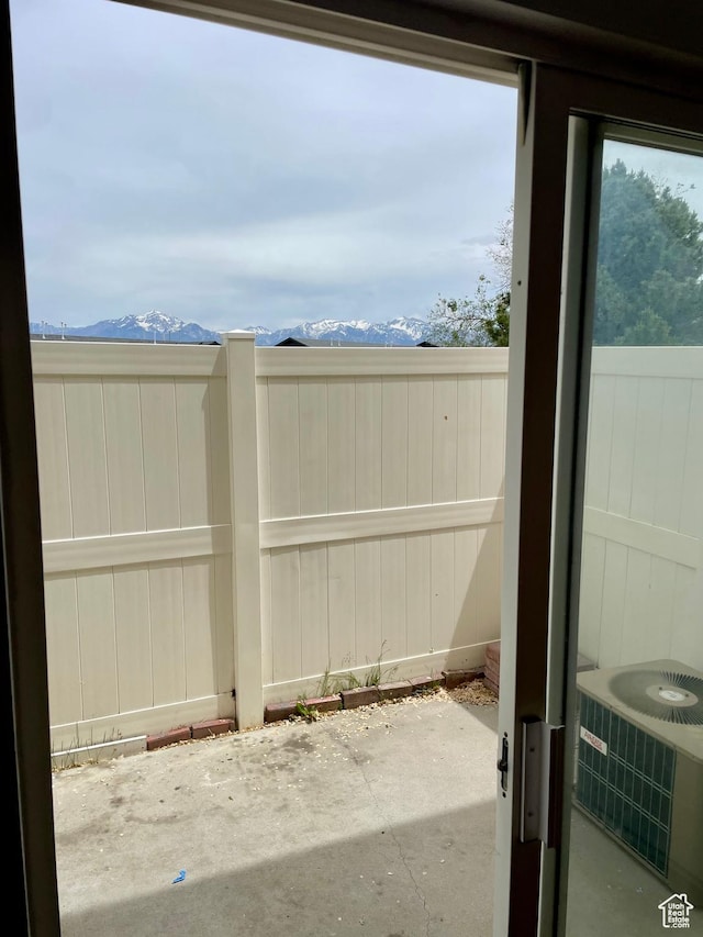 6939 S Florentine Way, West Jordan, UT 84084 - fenced backyard featuring a patio, a mountain view, and central AC unit